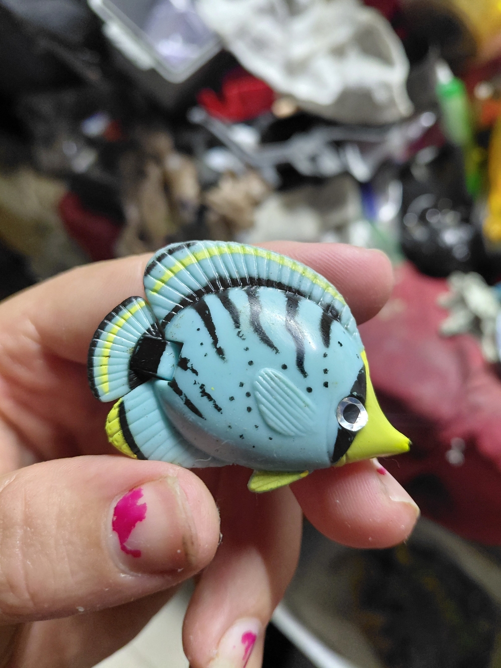 small, plastic toy tropical fish resembling a butterflyfish